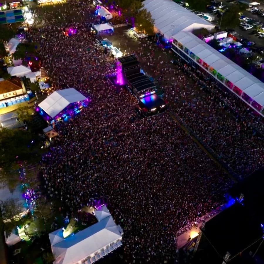 Aerial view of a large crowd at a vibrant outdoor event.
